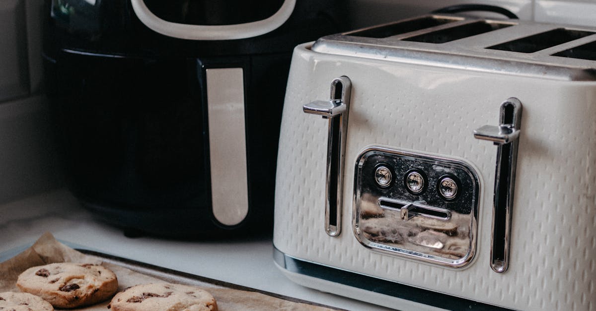 Freshly baked cookies on tray beside air fryer and toaster.