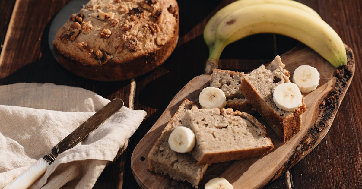 A rustic presentation of homemade banana bread with fresh bananas on a wooden board.