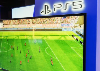 PS5 gaming console showcasing a soccer video game in a retail store setting.