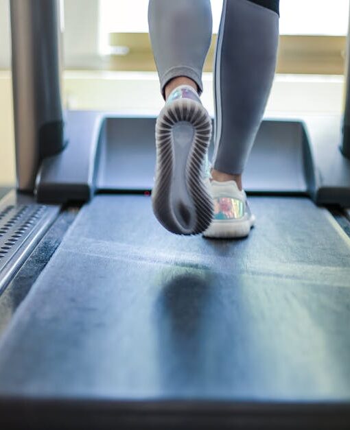 Close-up shot of a person exercising on a treadmill, showcasing fitness and health focus.