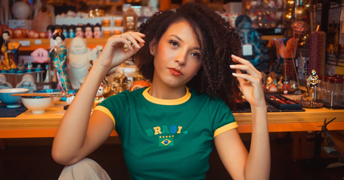 Portrait of a young woman in a vibrant setting wearing a Brazil t-shirt, seated indoors.