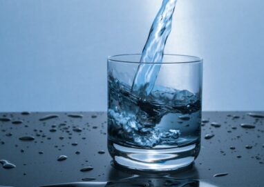 High-quality image of water being poured into a glass, illustrating hydration and purity.