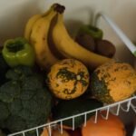 A vibrant assortment of fruits and vegetables on a kitchen rack, showcasing health and nutrition.