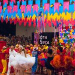 Colorful festival scene with dancers and decorations at a Brazilian celebration.