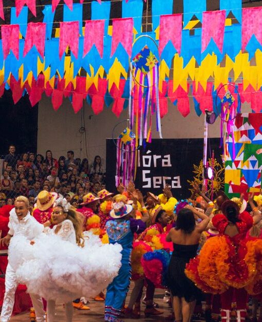 Colorful festival scene with dancers and decorations at a Brazilian celebration.
