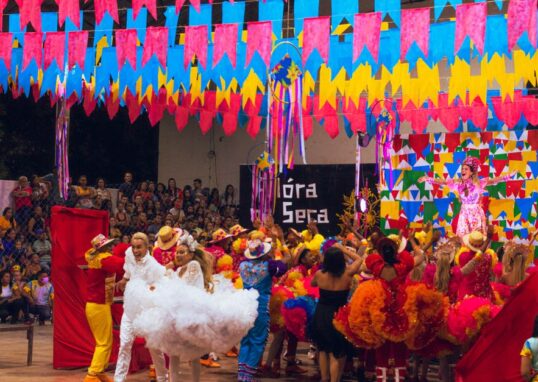 Colorful festival scene with dancers and decorations at a Brazilian celebration.