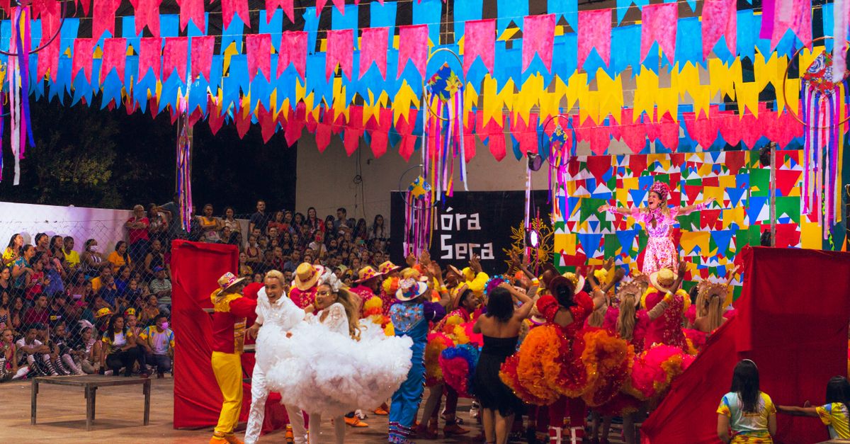 Colorful festival scene with dancers and decorations at a Brazilian celebration.