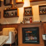 Cozy living room interior with a stylish fireplace and decorative shelving.