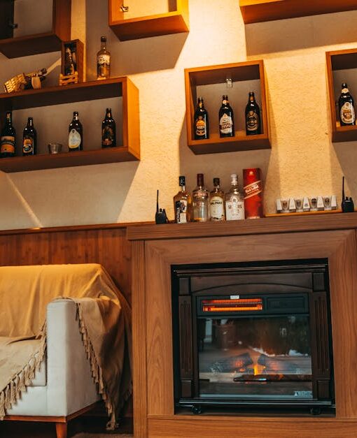 Cozy living room interior with a stylish fireplace and decorative shelving.